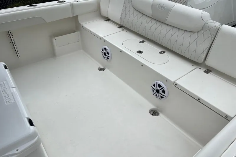Slide: The Image of 2026 Key West 239 FS boat interior with white seating and built-in speakers. - 20