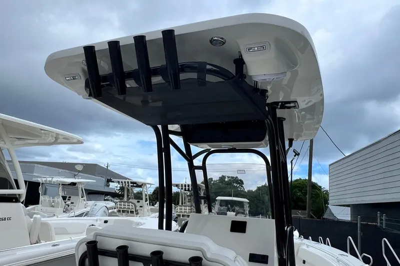 Slide: The Image of 2026 Key West 239 FS boat with T-top and rod holders, docked under cloudy skies. - 21