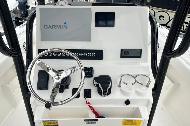 Slide: The Image of 2026 Key West 239 FS boat console with Garmin navigation and steering wheel. - 23