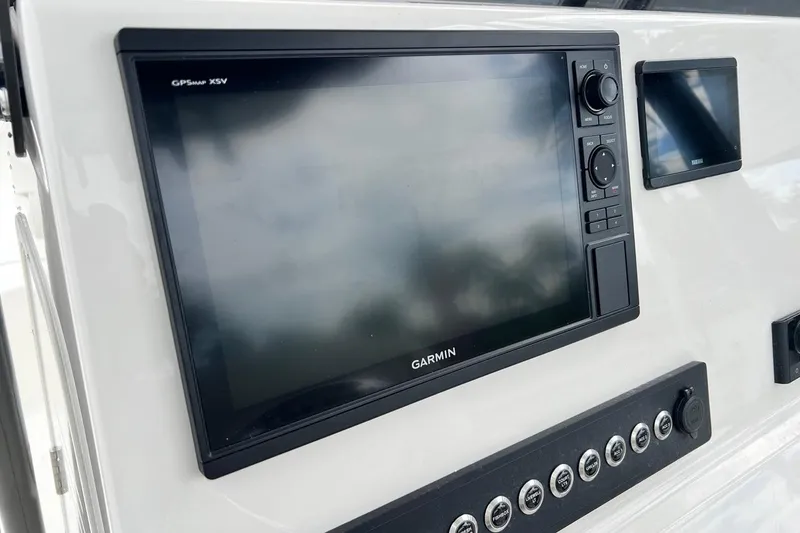 Slide: The Image of 2026 Key West 239 FS boat dashboard with Garmin GPS and control panel. - 25