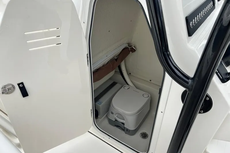 Slide: The Image of 2026 Key West 239 FS boat interior with compact marine toilet. - 34