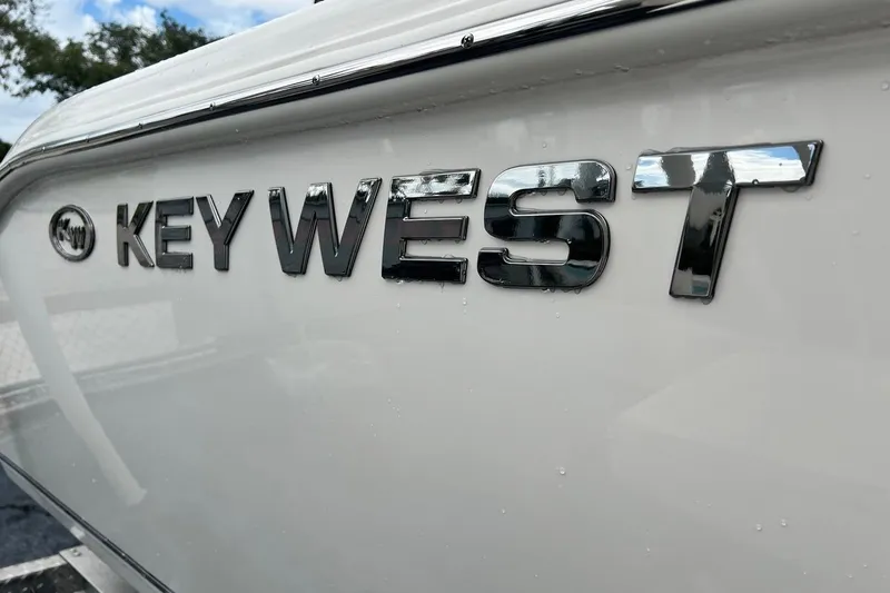 Slide: The Image of Key West 239 FS 2026 boat logo on white hull, close-up view. - 43