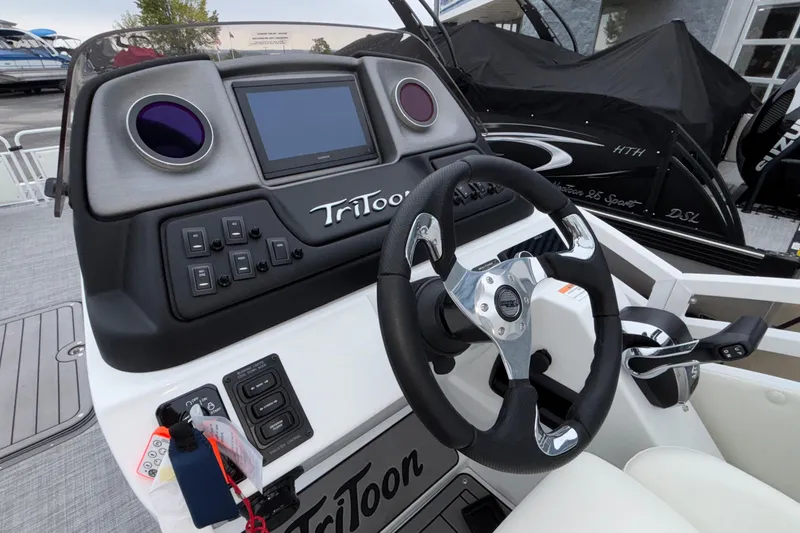 Slide: The Image of 2026 JC NEPTOON 27TT SPORT boat dashboard with steering wheel and control panel. - 13