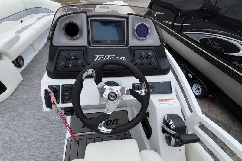Slide: The Image of Steering console of 2026 JC NEPTOON 27TT SPORT boat with modern controls and display. - 14