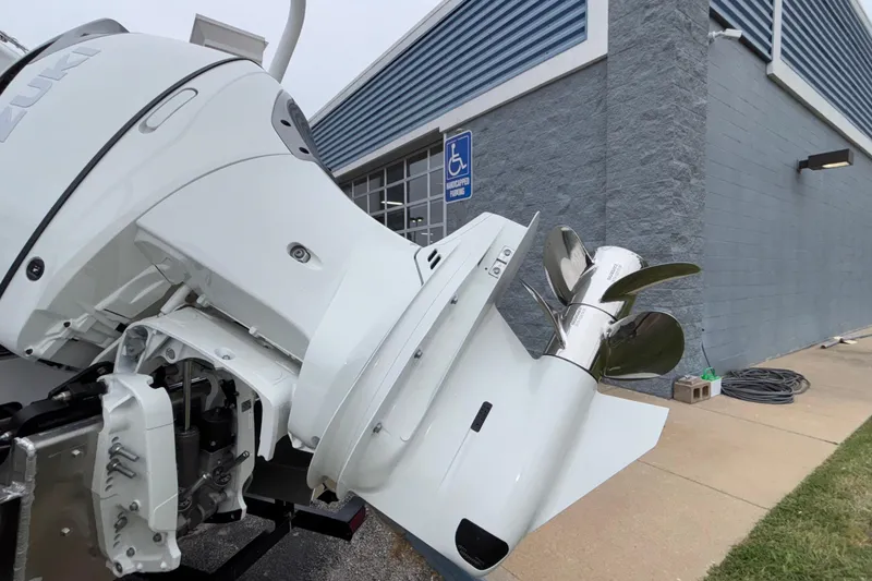 Slide: The Image of Outboard motor of 2026 JC NEPTOON 27TT SPORT near a building with handicap parking. - 25
