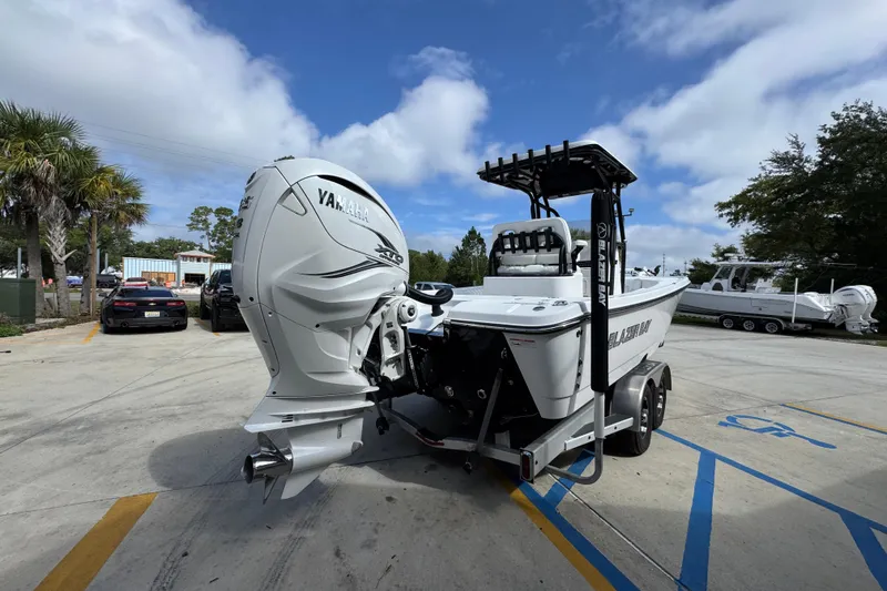 Slide: The Image of 2021 Blazer Bay 2700 Hybrid boat with Yamaha engine on trailer in parking lot. - 11
