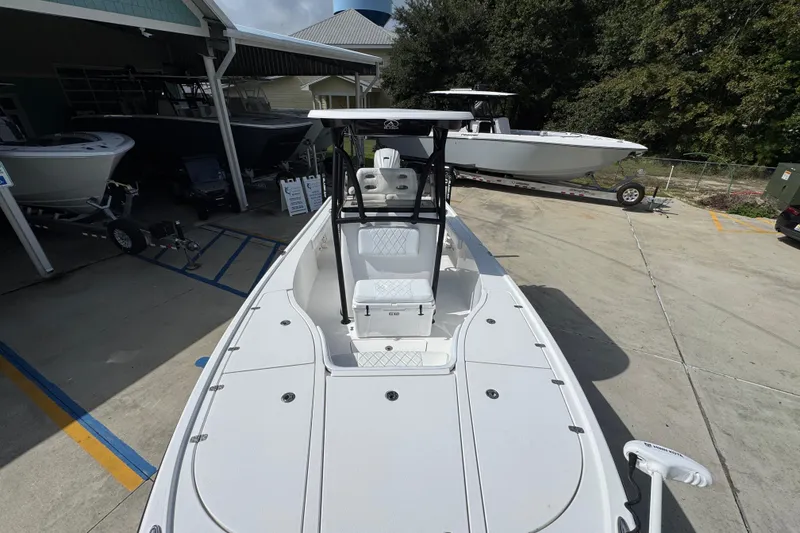 Slide: The Image of 2021 Blazer Bay 2700 Hybrid boat displayed outdoors at a dealership. - 19