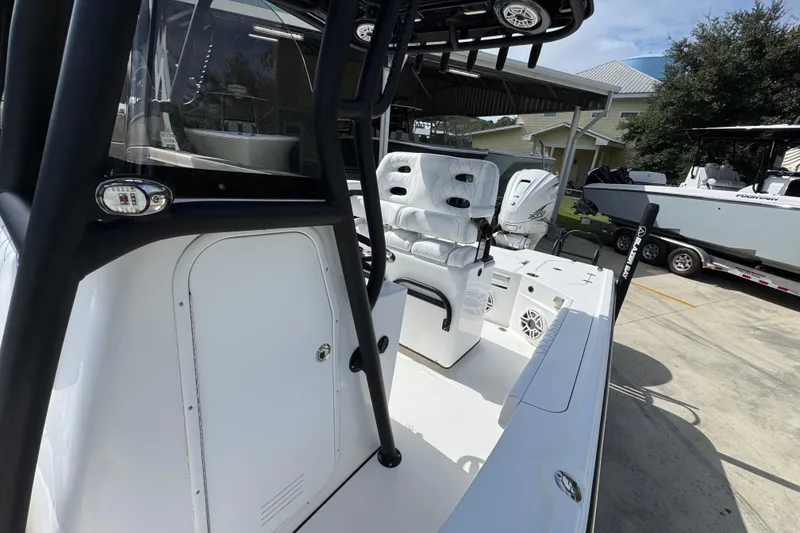 Slide: The Image of 2021 Blazer Bay 2700 Hybrid boat interior with seating and controls. - 21