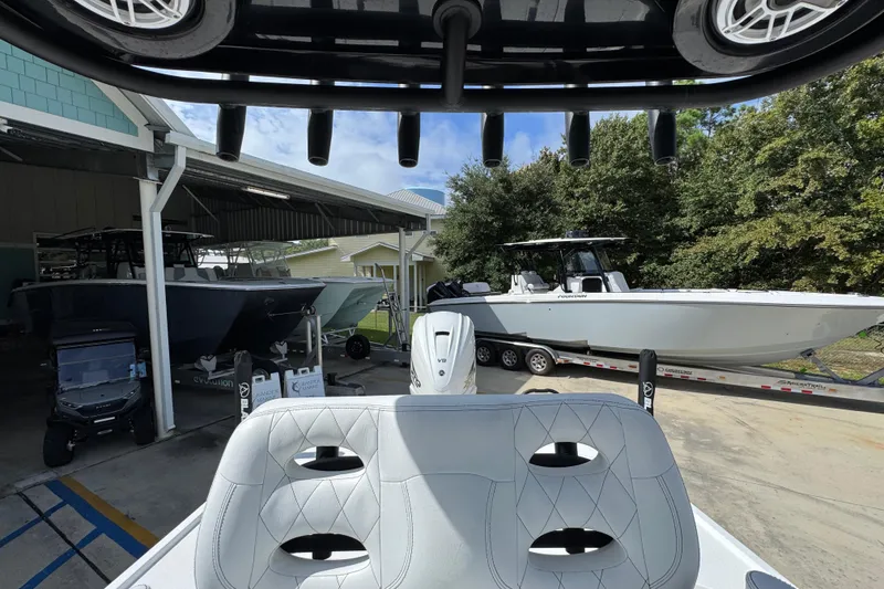 Slide: The Image of 2021 Blazer Bay 2700 Hybrid boat in a marina with other vessels. - 25