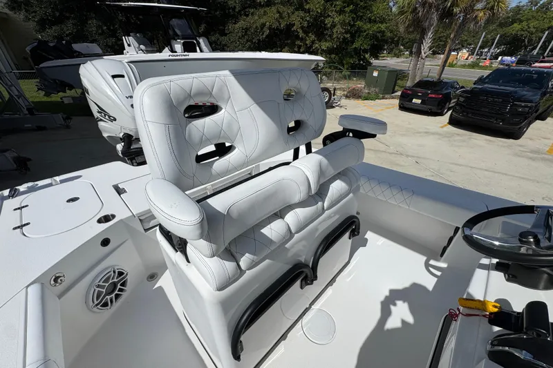 Slide: The Image of 2021 Blazer Bay 2700 Hybrid boat interior with white seating and steering console. - 30