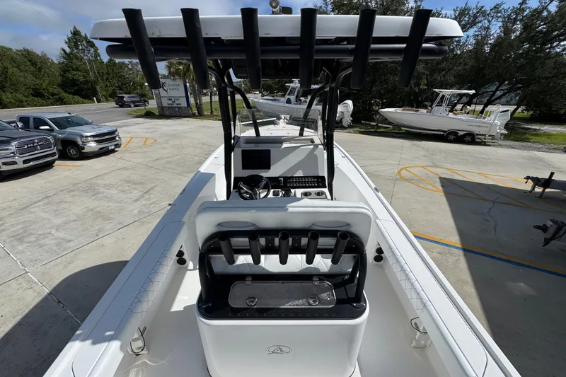 Slide: The Image of 2021 Blazer Bay 2700 Hybrid boat with T-top and console, parked outdoors. - 31