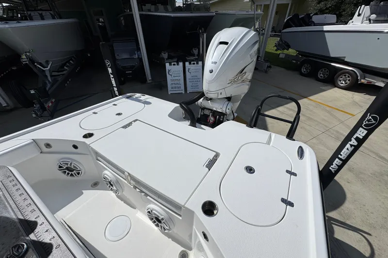 Slide: The Image of 2021 Blazer Bay 2700 Hybrid boat with Yamaha V8 engine, docked at a marina. - 32