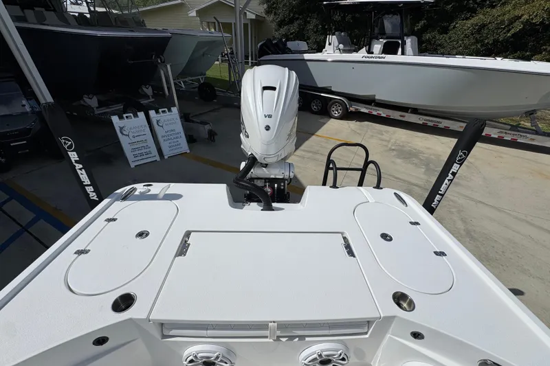 Slide: The Image of 2021 Blazer Bay 2700 Hybrid boat with V8 engine, displayed at a dealership. - 33