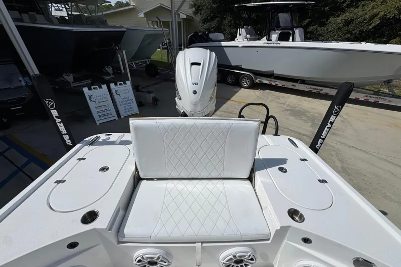 Slide: The Image of 2021 Blazer Bay 2700 Hybrid boat interior with white seating and V8 engine. - 34