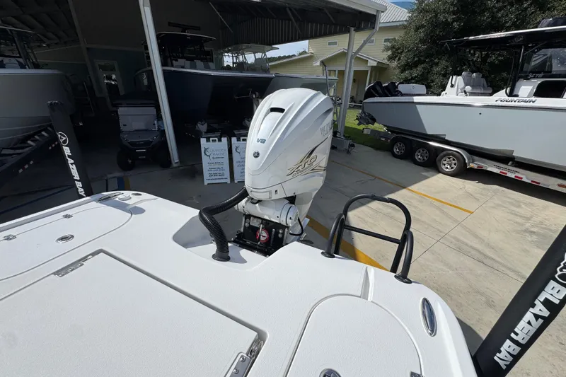 Slide: The Image of 2021 Blazer Bay 2700 Hybrid boat with powerful V8 engine in a marina setting. - 35