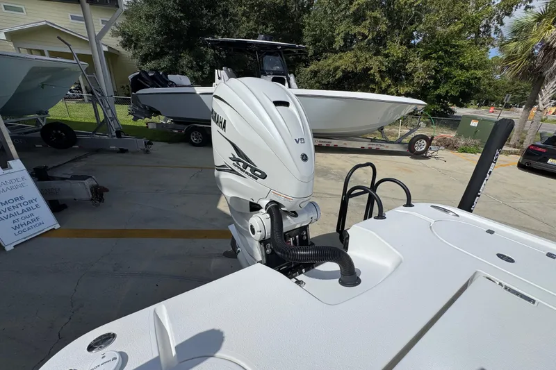 Slide: The Image of 2021 Blazer Bay 2700 Hybrid boat with Yamaha V8 engine in a marina setting. - 36