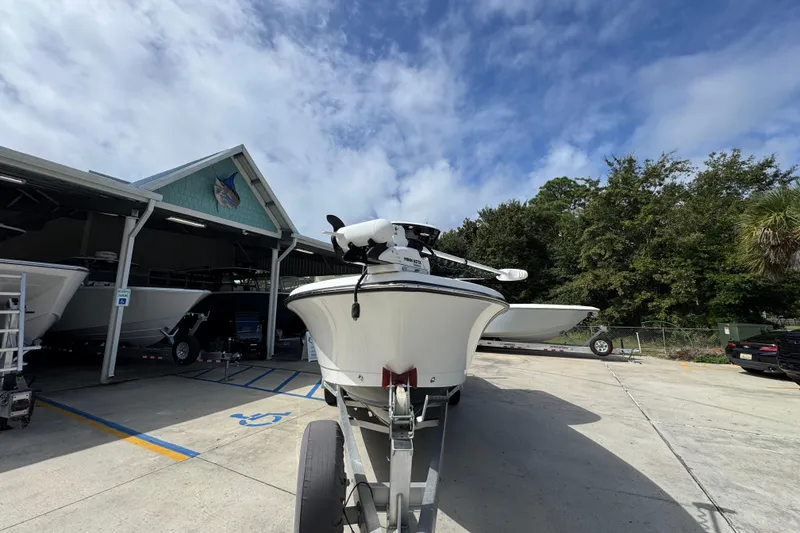 Slide: The Image of 2021 Blazer Bay 2700 Hybrid boat on trailer at marina under blue sky. - 5