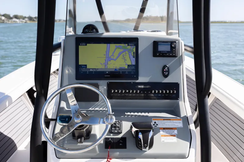 Slide: The Image of 2023 Pathfinder 2700 Open boat dashboard with navigation system and steering wheel. - 23