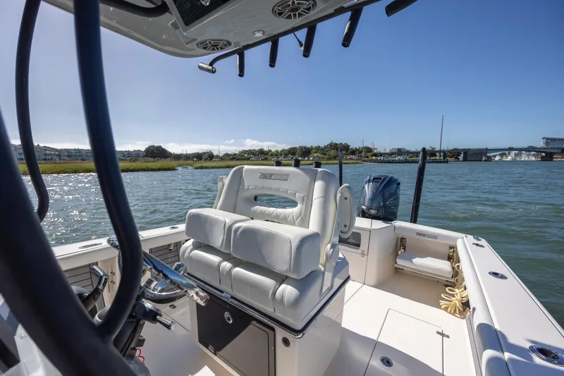 Slide: The Image of 2023 Pathfinder 2700 Open boat interior with helm seat and water view. - 24