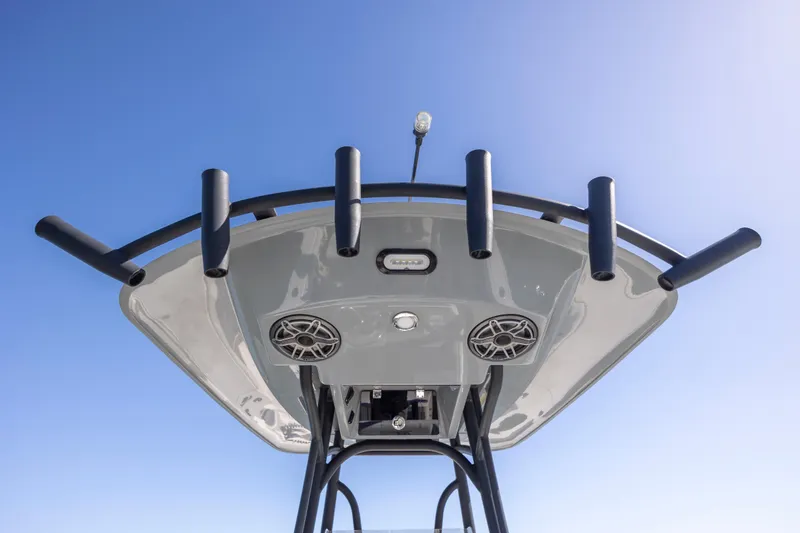 Slide: The Image of 2023 Pathfinder 2700 Open boat top view with rod holders and speakers against blue sky. - 25