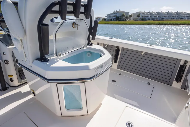 Slide: The Image of 2023 Pathfinder 2700 Open boat interior with livewell, near waterfront homes. - 26
