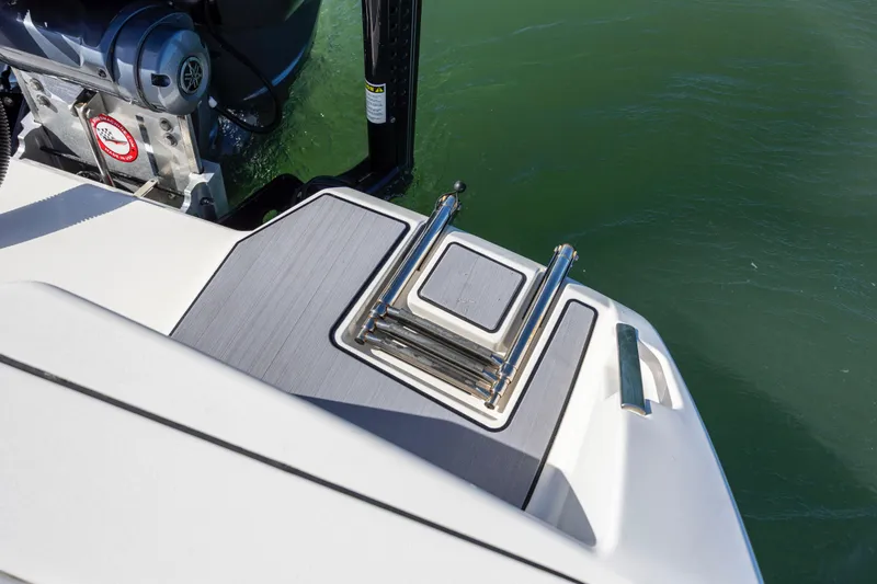 Slide: The Image of 2023 Pathfinder 2700 Open boat with a folded swim ladder and outboard motor. - 28