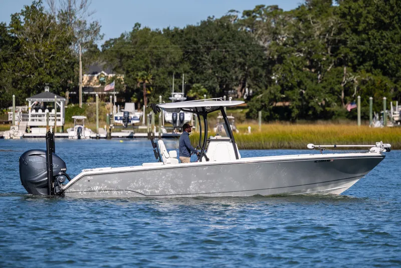 Slide: The Image of 2023 Pathfinder 2700 Open boat cruising on a scenic waterway with lush greenery. - 8