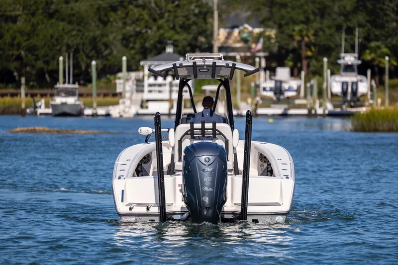 Slide: The Image of 2023 Pathfinder 2700 Open boat cruising on a calm waterway with scenic background. - 9