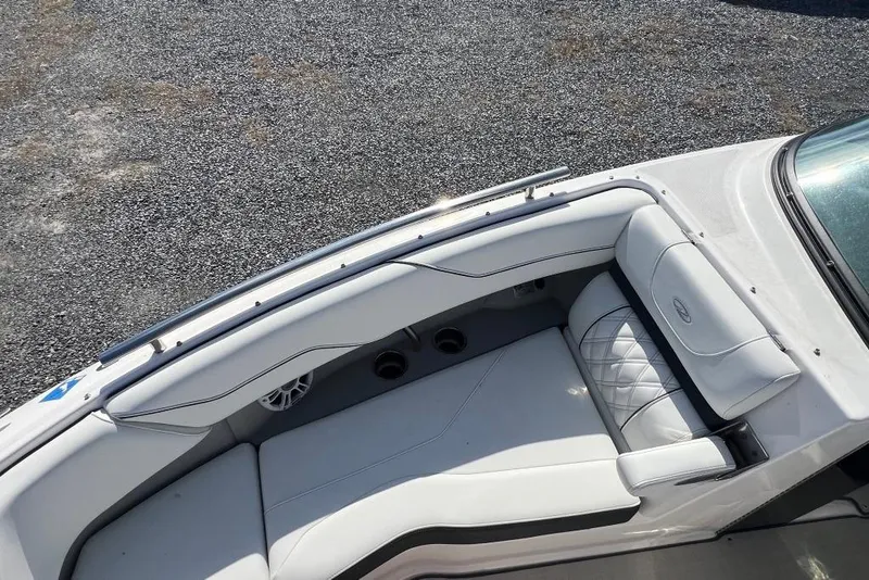 Slide: The Image of 2023 Regal LX4 boat interior with white cushioned seating and sleek design. - 11