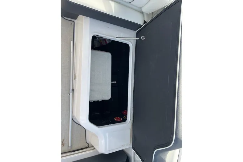 Slide: The Image of 2023 Regal LX4 boat storage compartment with open door, showcasing interior space. - 13