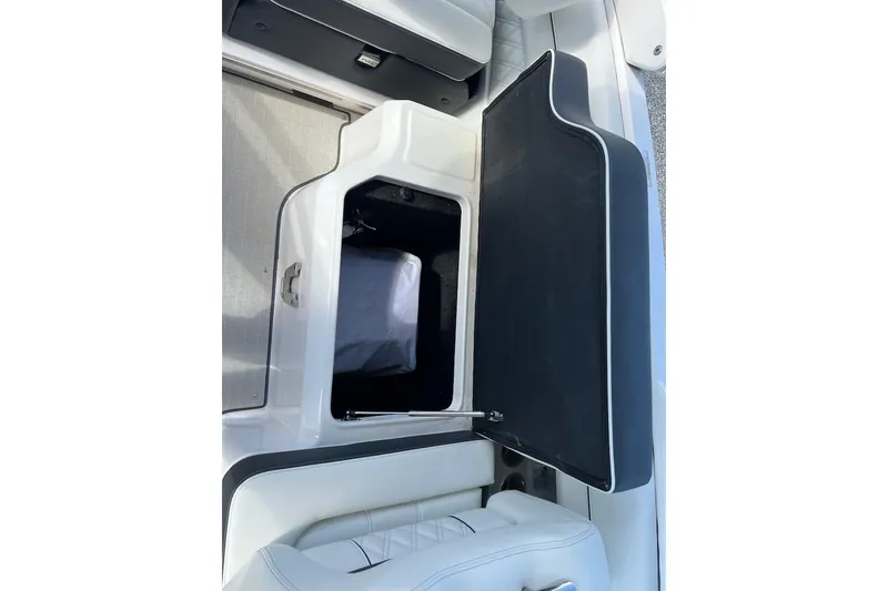 Slide: The Image of 2023 Regal LX4 boat storage compartment with open lid, showcasing interior space. - 14