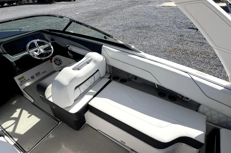 Slide: The Image of 2023 Regal LX4 boat interior with sleek white seating and modern dashboard design. - 4