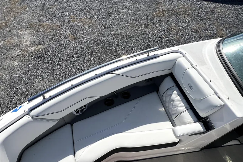 Slide: The Image of 2023 Regal LX4 boat interior with white cushioned seating and sleek design. - 5