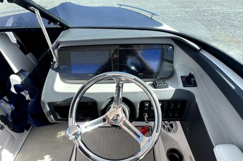 Slide: The Image of 2023 Regal LX4 boat dashboard with steering wheel and digital displays. - 6