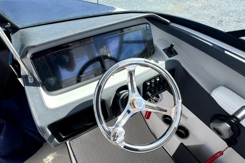 Slide: The Image of 2023 Regal LX4 boat dashboard with modern steering wheel and touchscreen controls. - 7
