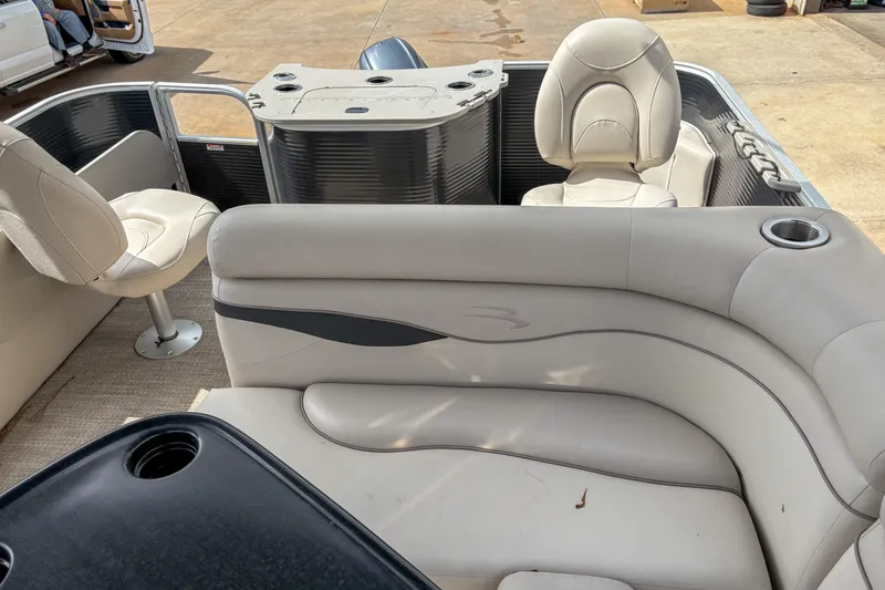 Slide: The Image of 2018 Bennington SX 20 pontoon boat interior with beige seating and cup holders. - 10
