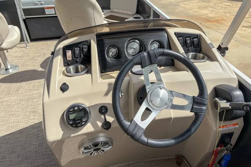 Slide: The Image of 2018 Bennington SX 20 boat dashboard with steering wheel and control panel. - 12
