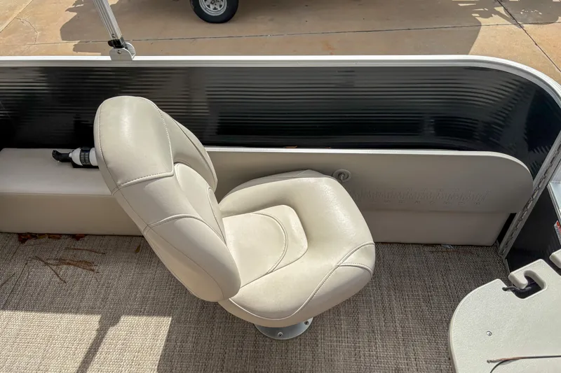 Slide: The Image of 2018 Bennington SX 20 boat interior with beige captain's chair and carpeted floor. - 14