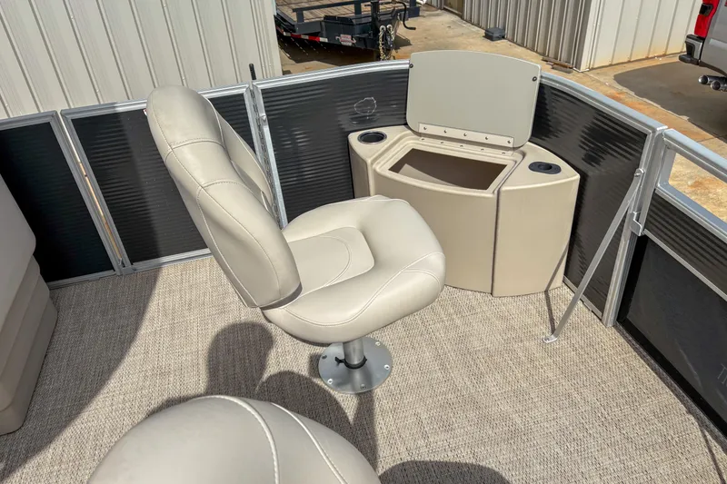 Slide: The Image of 2018 Bennington SX 20 boat interior with beige seating and storage compartment. - 8