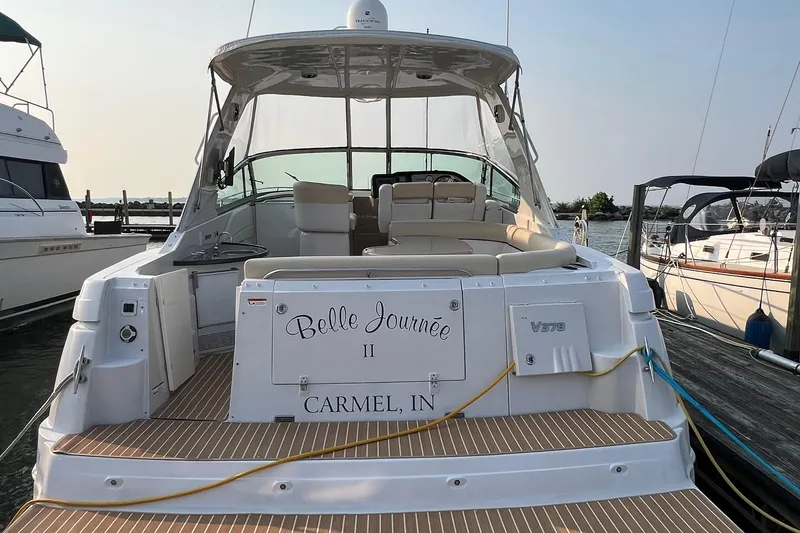 Slide: The Image of 2008 Four Winns 378 Vista yacht docked, rear view with seating and "Belle Journée" name. - 11