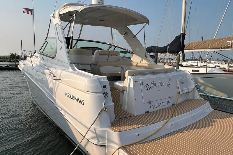 Slide: The Image of 2008 Four Winns 378 Vista yacht docked, featuring spacious seating and elegant design. - 12