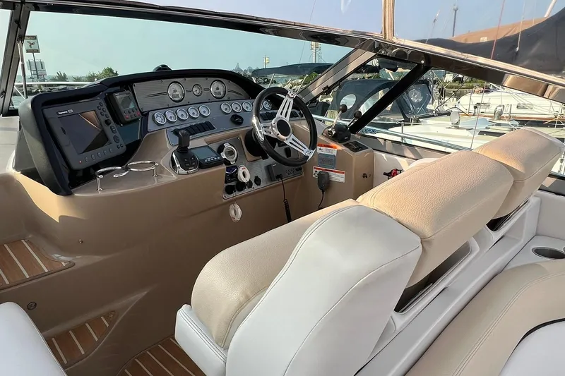 Slide: The Image of 2008 Four Winns 378 Vista boat cockpit with steering wheel and navigation controls. - 17