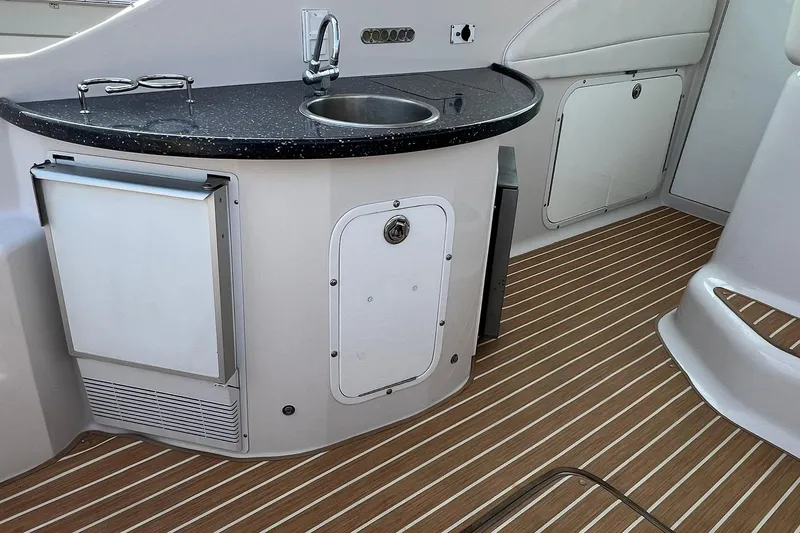 Slide: The Image of 2008 Four Winns 378 Vista boat interior with kitchenette and wood-patterned flooring. - 22