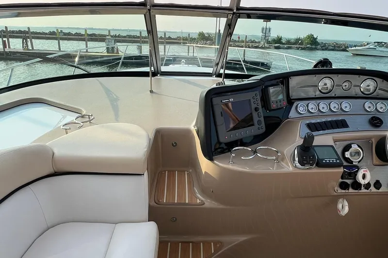 Slide: The Image of 2008 Four Winns 378 Vista boat cockpit with navigation controls and waterfront view. - 27