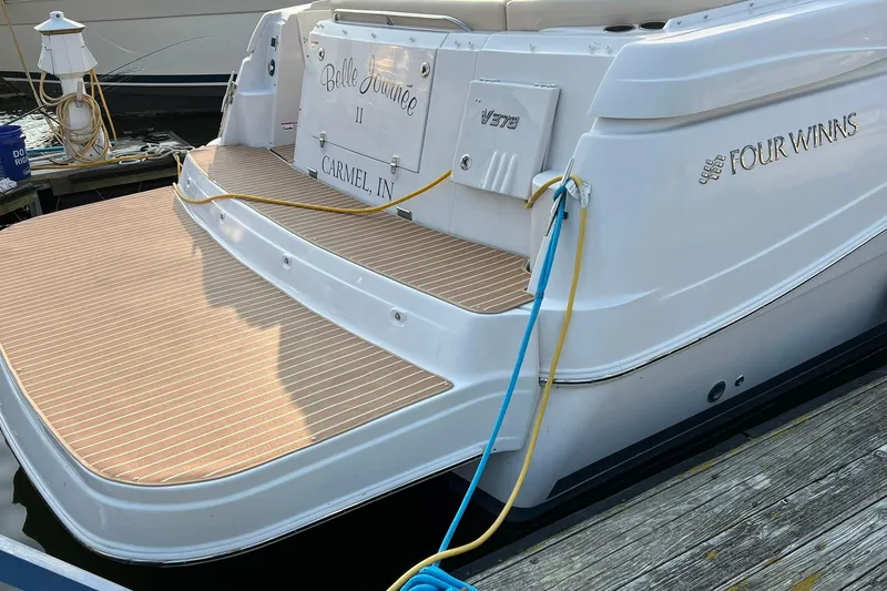 Slide: The Image of 2008 Four Winns 378 Vista yacht docked, featuring a spacious swim platform. - 3