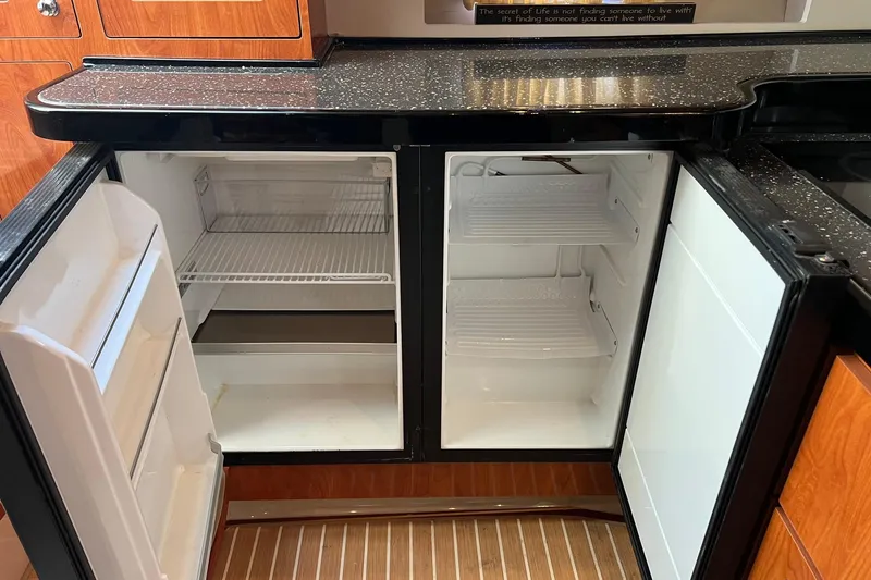 Slide: The Image of 2008 Four Winns 378 Vista yacht kitchen with open refrigerator and wooden cabinetry. - 42