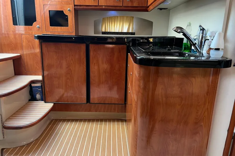 Slide: The Image of 2008 Four Winns 378 Vista yacht interior with wood cabinetry and compact kitchen area. - 44