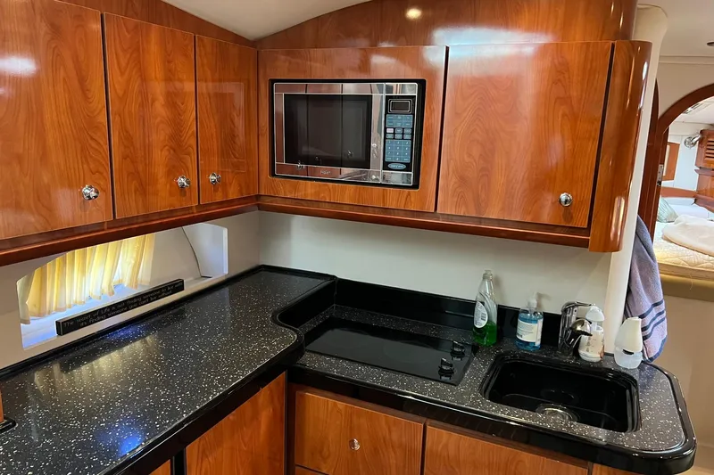 Slide: The Image of Luxurious 2008 Four Winns 378 Vista yacht kitchen with wood cabinets and modern appliances. - 45