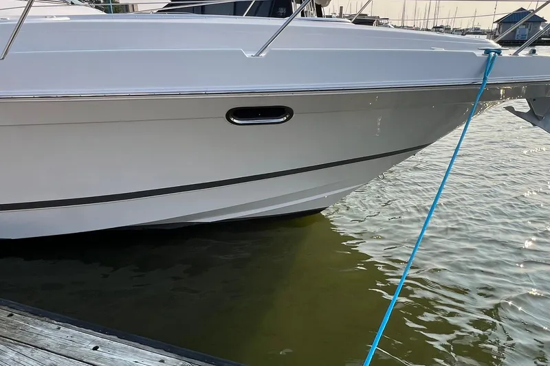 Slide: The Image of 2008 Four Winns 378 Vista yacht docked, side view with blue mooring line. - 9