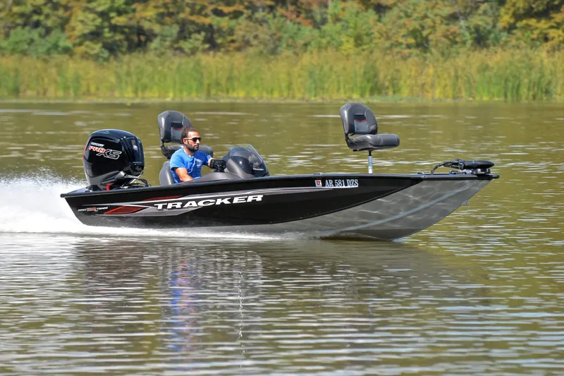 The Image of 2023 Bass Tracker PRO TEAM 190 boat cruising on a calm lake. - 1